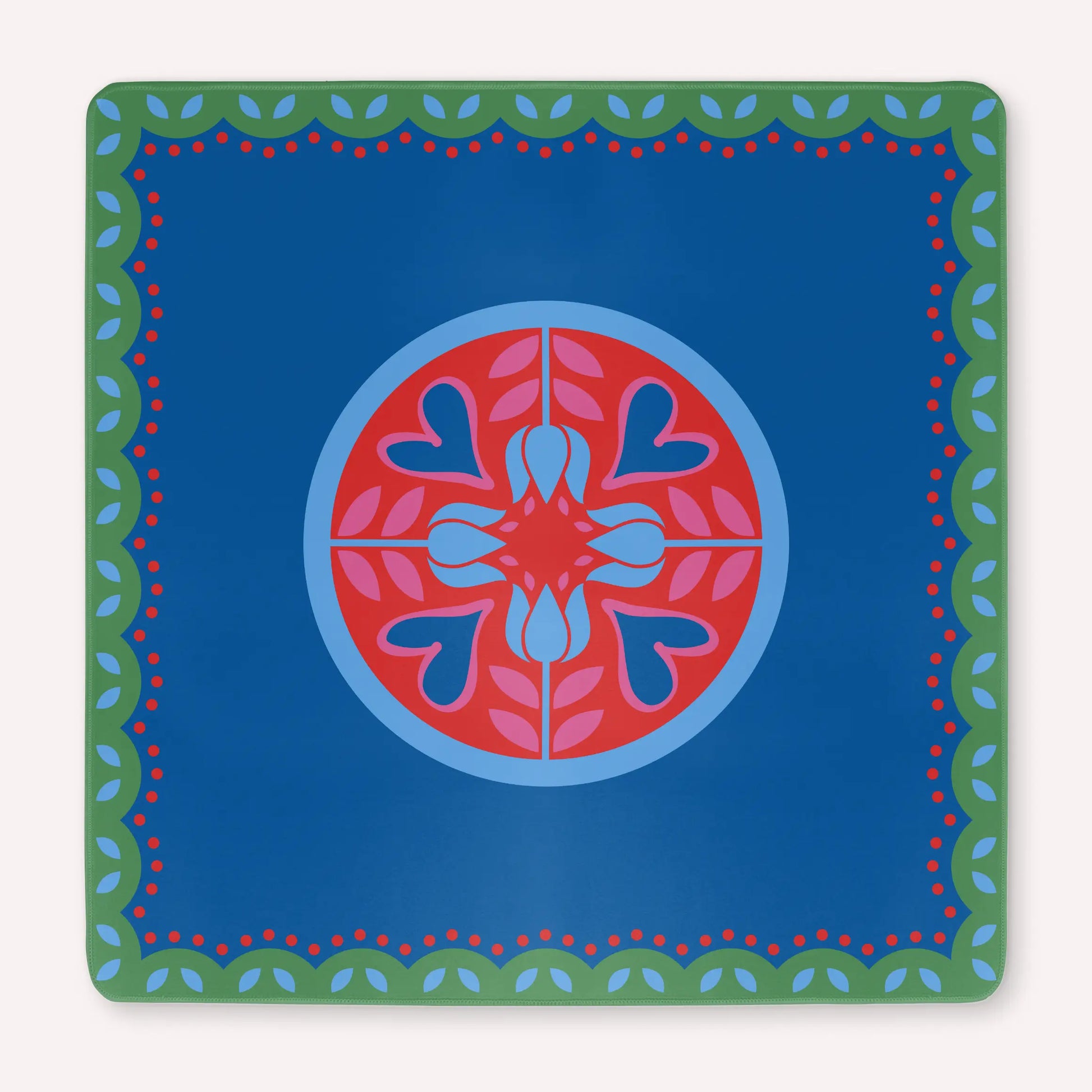 Mockup of a luxury Hearts & Flowers mahjong mat featuring vivid azure and red tones with soft gray green details and subtle pink accents, designed in a bright floral and holiday-inspired style.