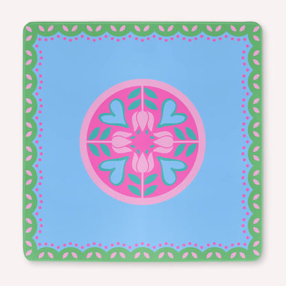 Mockup of the Hearts & Flowers mahjong mat featuring pastel azure, green, vivid magenta, light magenta, and cyan tones in a bright floral-inspired design with playful heart accents.