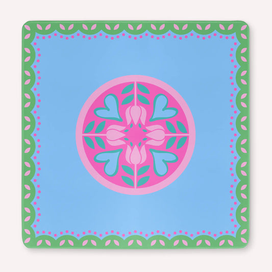 Mockup of the Hearts & Flowers mahjong mat featuring pastel azure, green, vivid magenta, light magenta, and cyan tones in a bright floral-inspired design with playful heart accents.