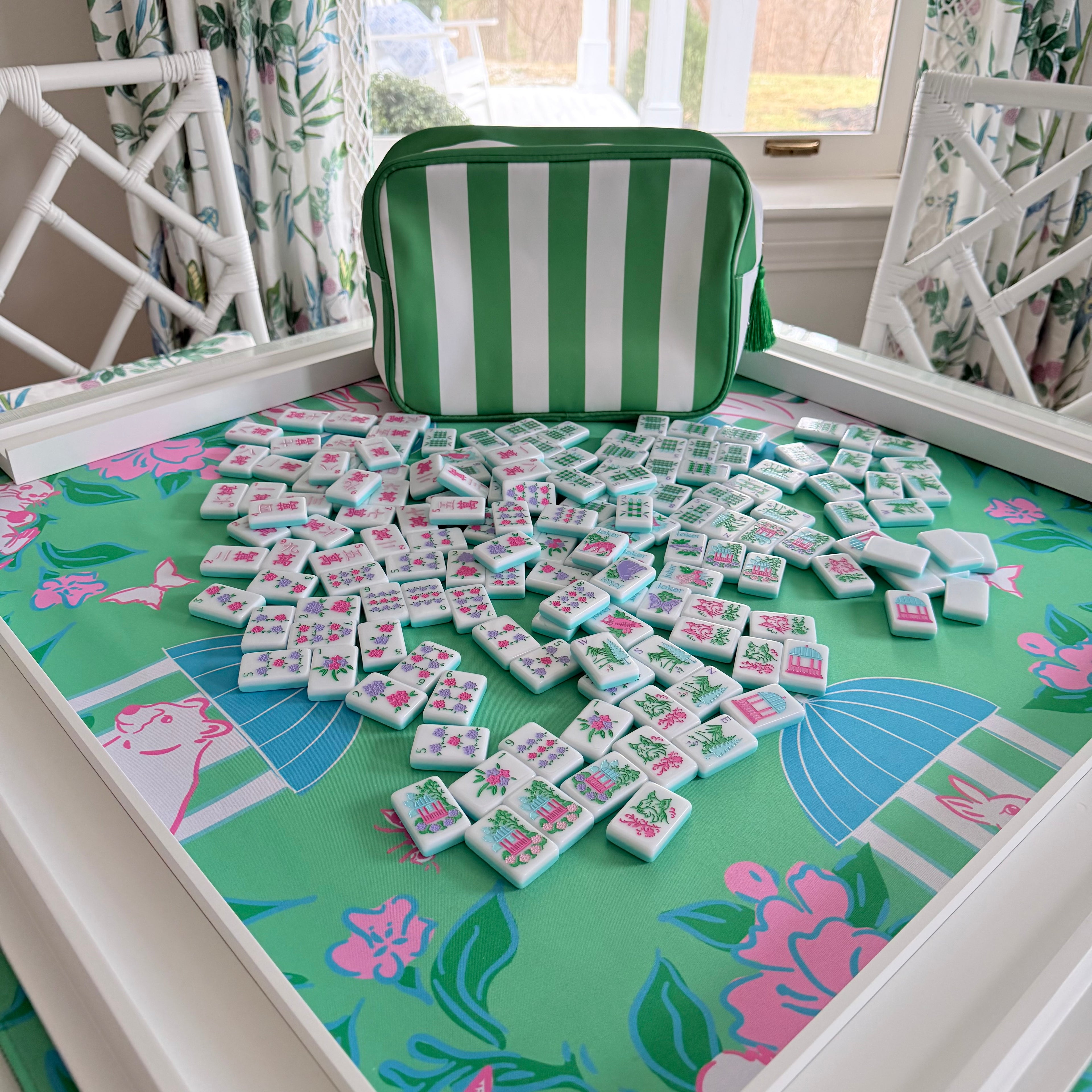 Southern Springs American mahjong tile set in play with racks and green striped storage bag