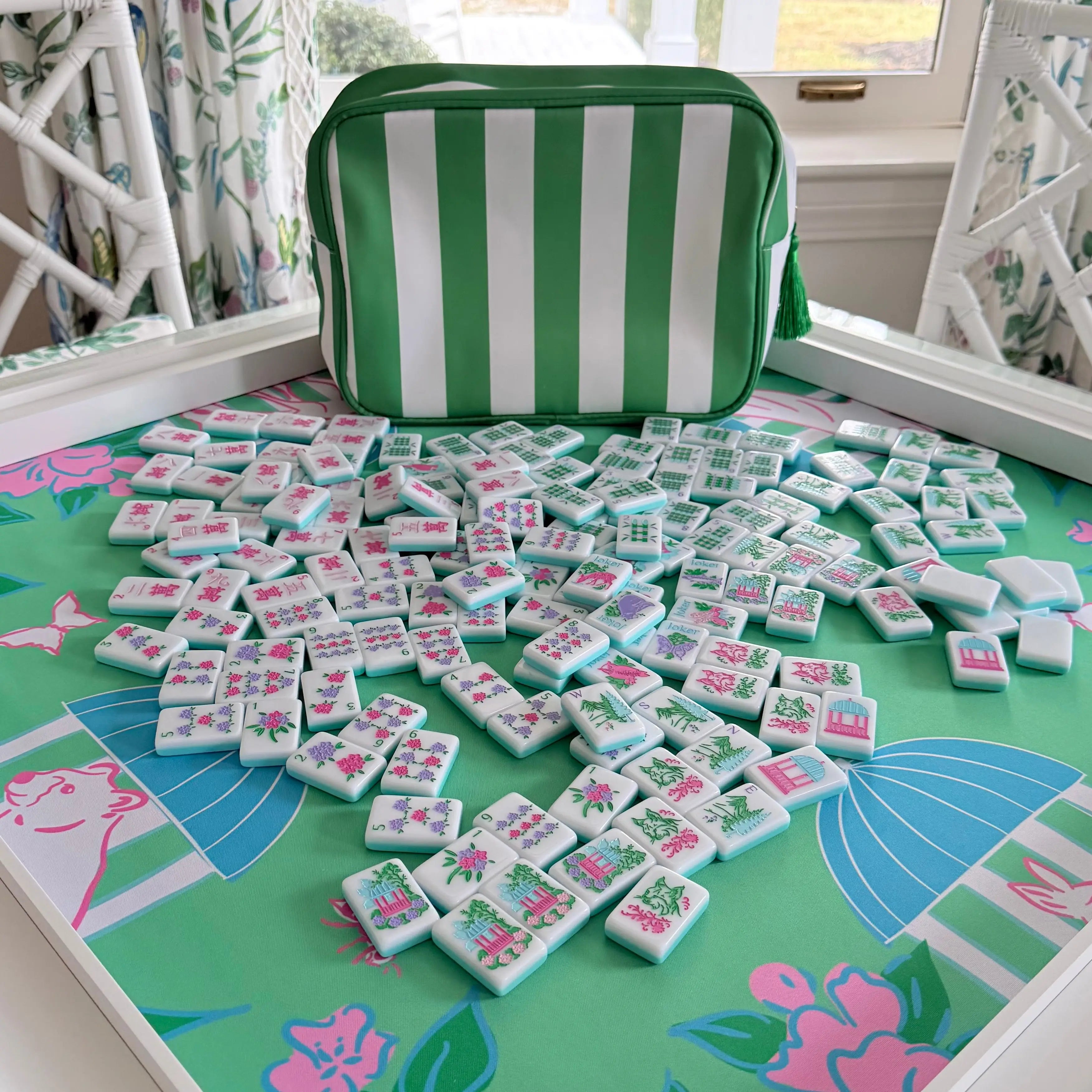 Southern Springs American mahjong tile set in play with racks and green striped storage bag