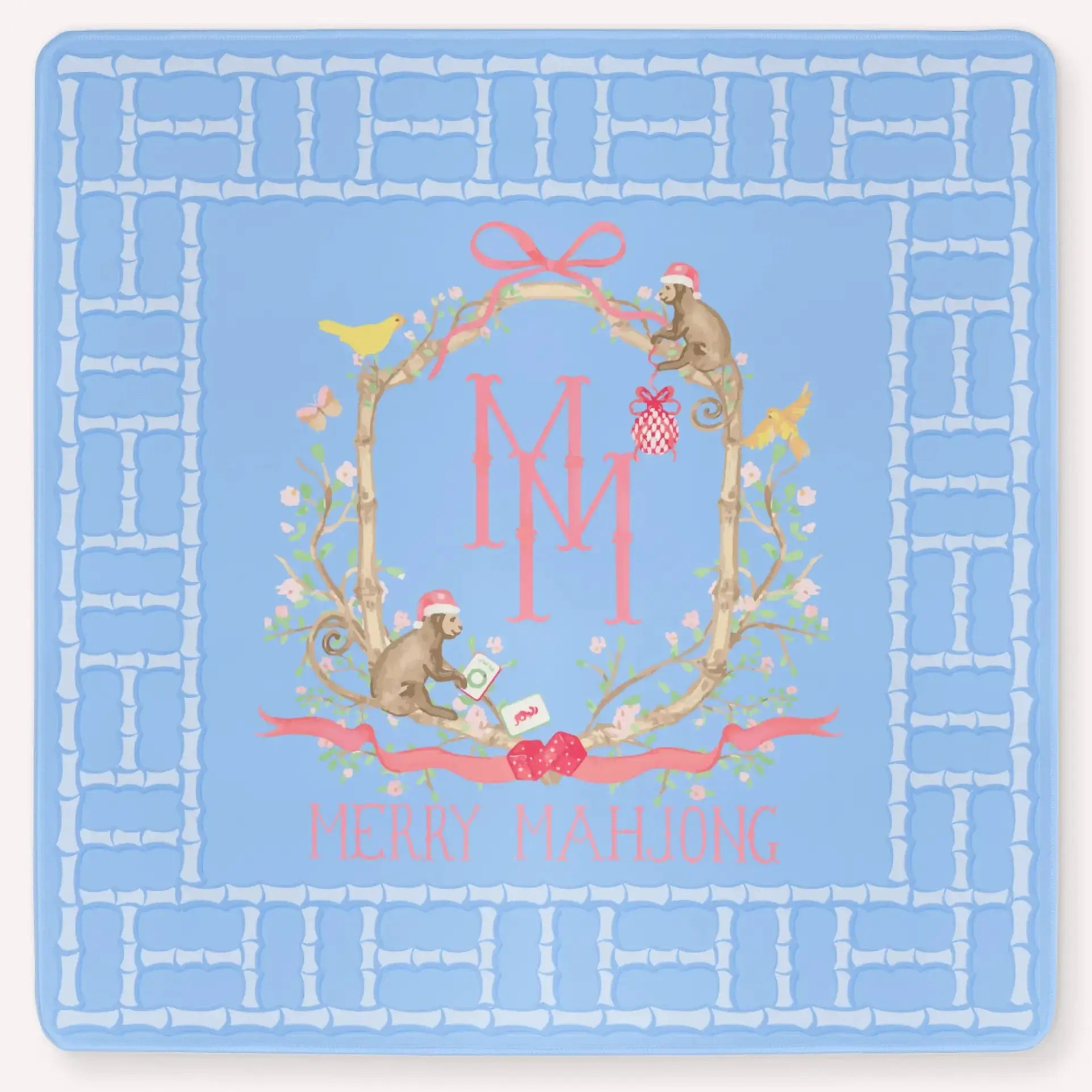 The Bamboo Blossom Christmas Edition Mahjong Mat featuring a festive bamboo lattice border design, monkeys with Christmas hats, ornaments, bows, birds, flowers and leaves with the Merry Mahjong Logo.