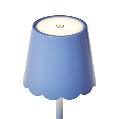Close-up of scalloped shade on blue LED table lamp