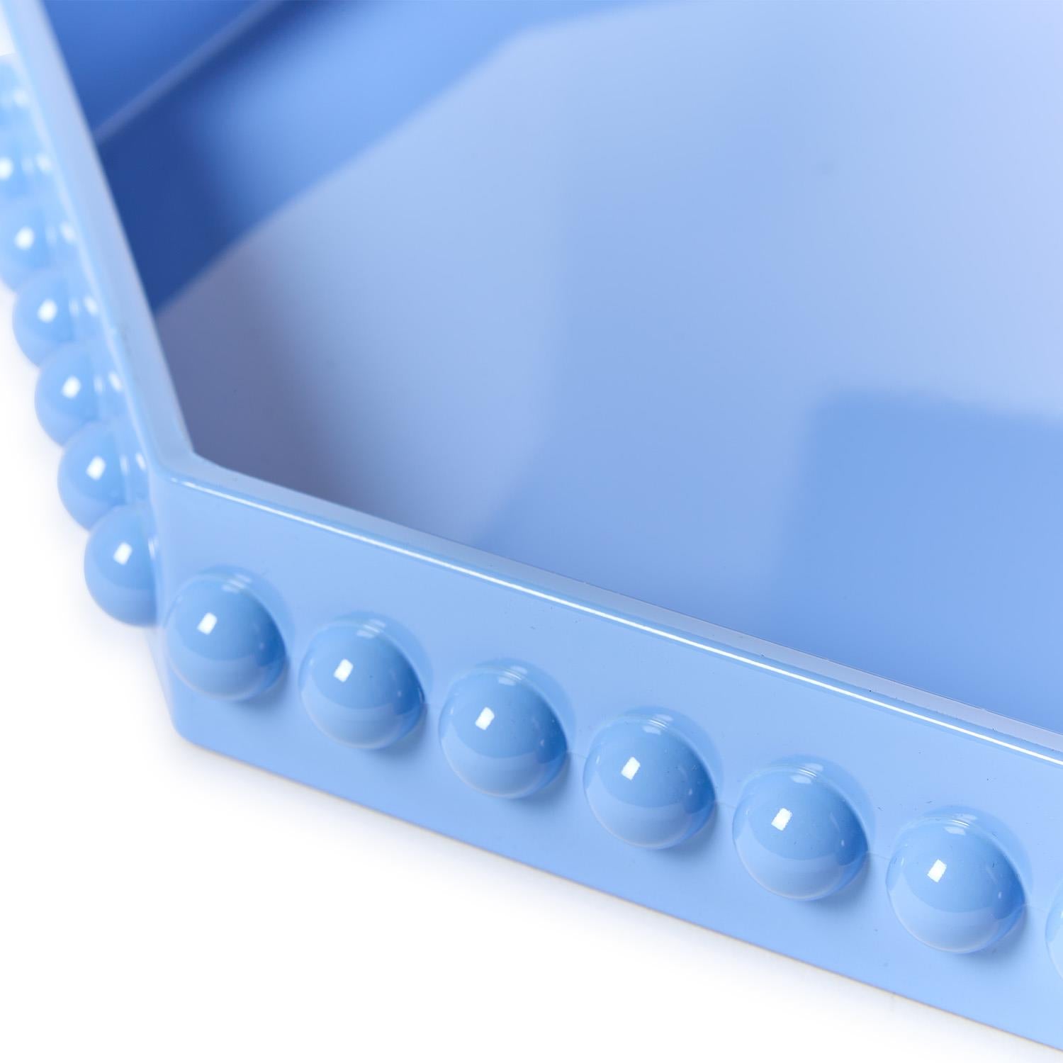Close-up of hobnail edge detail on blue octagonal lacquered tray