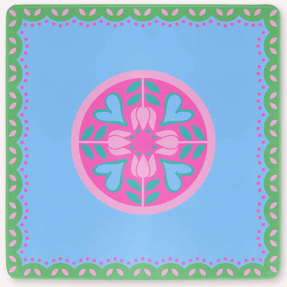 Mockup of the Hearts & Flowers mahjong mat featuring pastel azure, green, vivid magenta, light magenta, and cyan tones in a bright floral-inspired design with playful heart accents.
