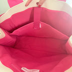 Empty interior of a hot pink Mahjong tote bag showcasing spacious storage and organization compartments.