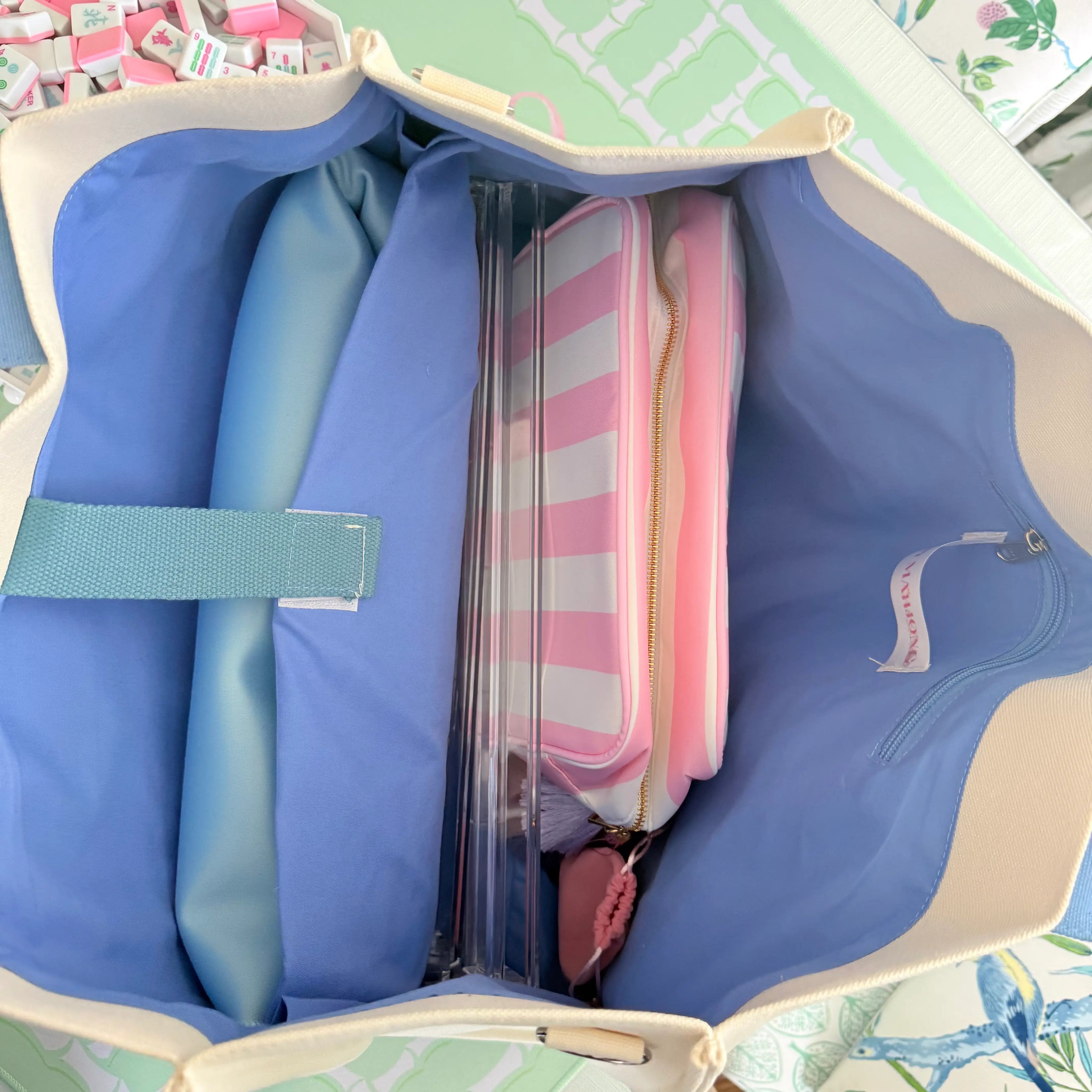 spacious light blue Mahjong tote bag filled with Mahjong tiles, racks, mats, and accessories to demonstrate capacity.
