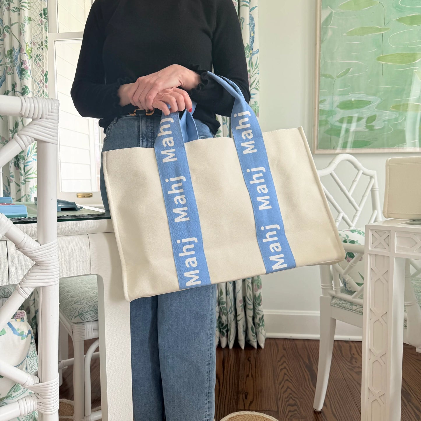 Light blue oversized Mahjong tote bag being carried by its handles.