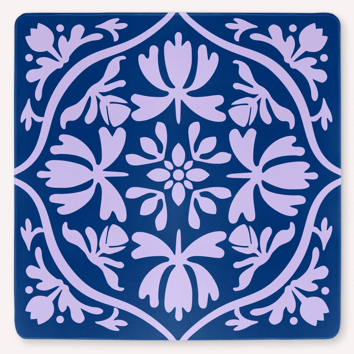 Tulip Terrace Lilac Current Mahjong mat mockup featuring soft lilac tulips on a deep sea blue background.