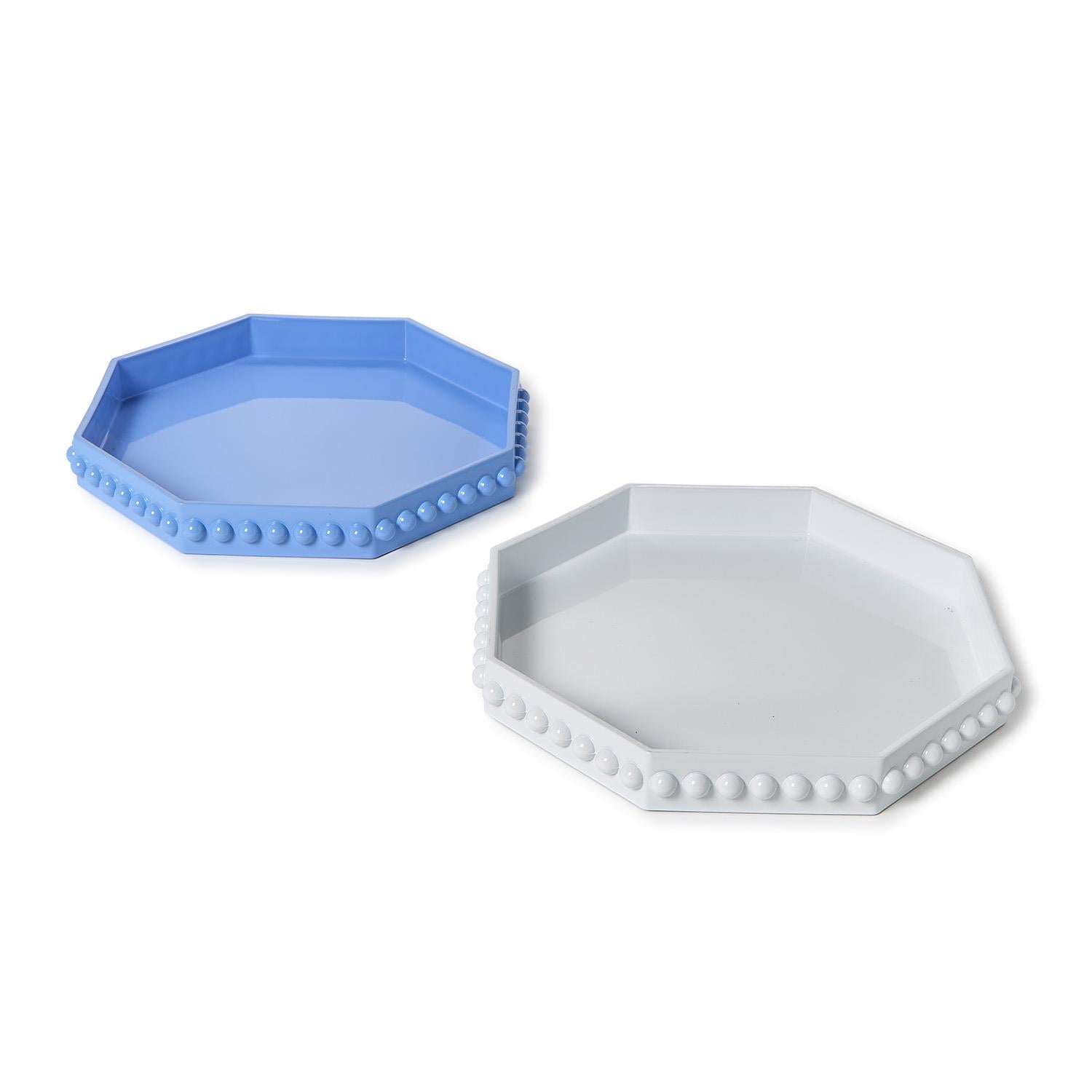 Angled view of octagonal lacquered trays with hobnail edge in blue and white side by side