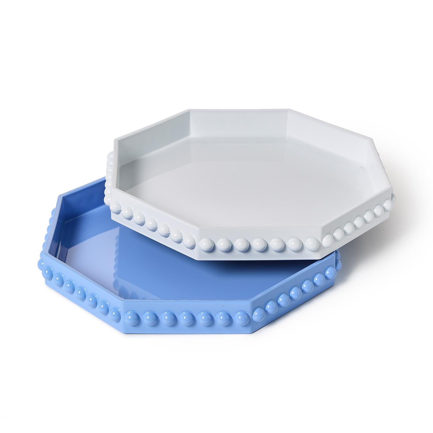 Stacked octagonal lacquered trays with hobnail edge in blue and white