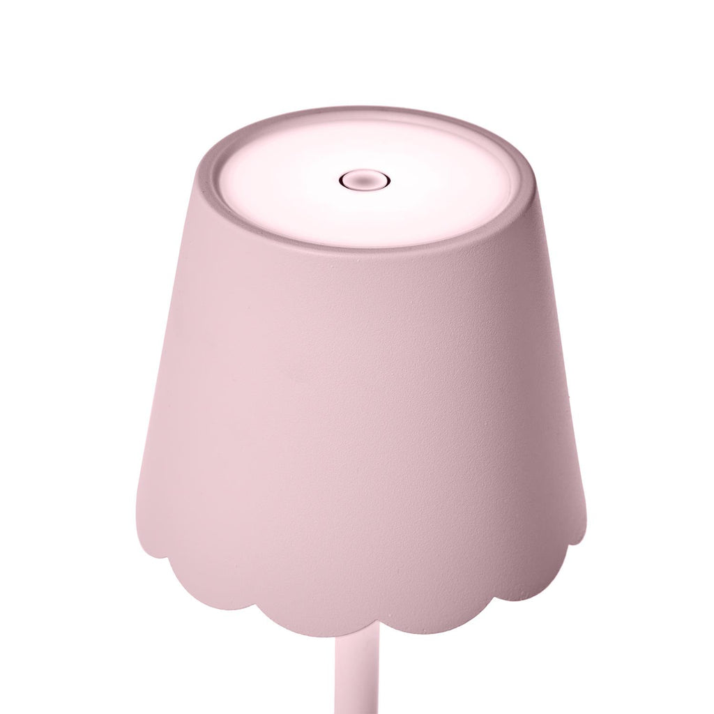 Close-up of scalloped shade on pink LED table lamp