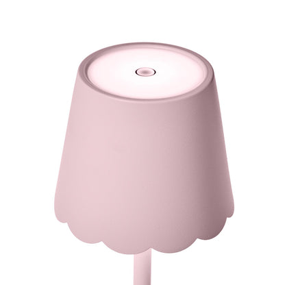 Close-up of scalloped shade on pink LED table lamp