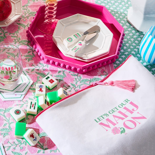 Pink octagonal lacquered tray with hobnail edge styled with decorative accessories