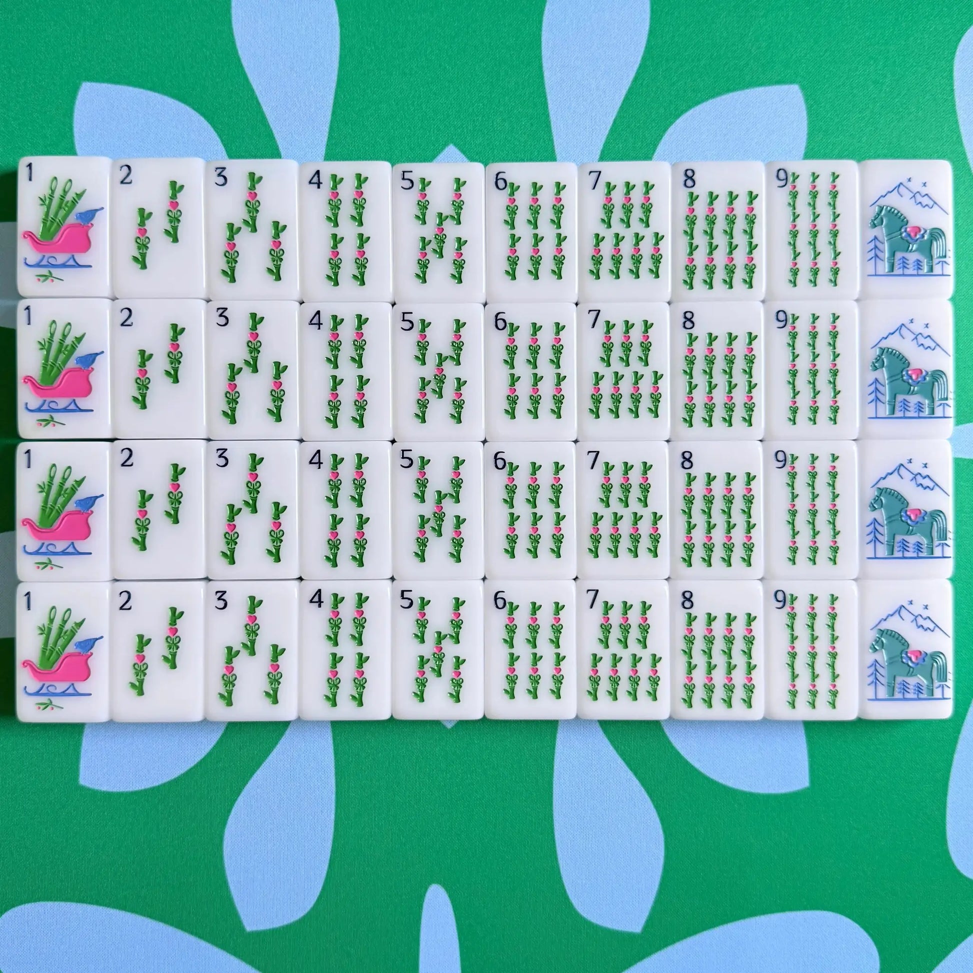 The Scandinavian Christmas Mahjong Collection's bams and green dragons displayed as they come packaged.