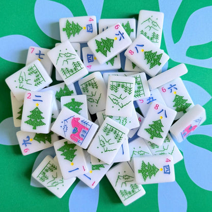 The Scandinavian Christmas Mahjong Collection's cracks displayed on the Emerald Mist Mahjong Mat.