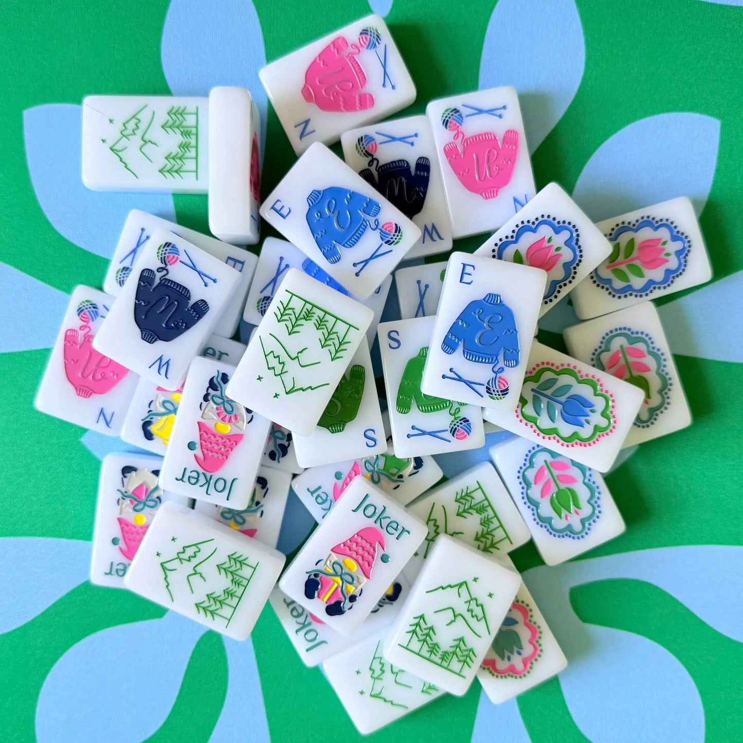 The Scandinavian Christmas Mahjong Collection's winds and jokers displayed on the Emerald Mist Mahjong Mat.