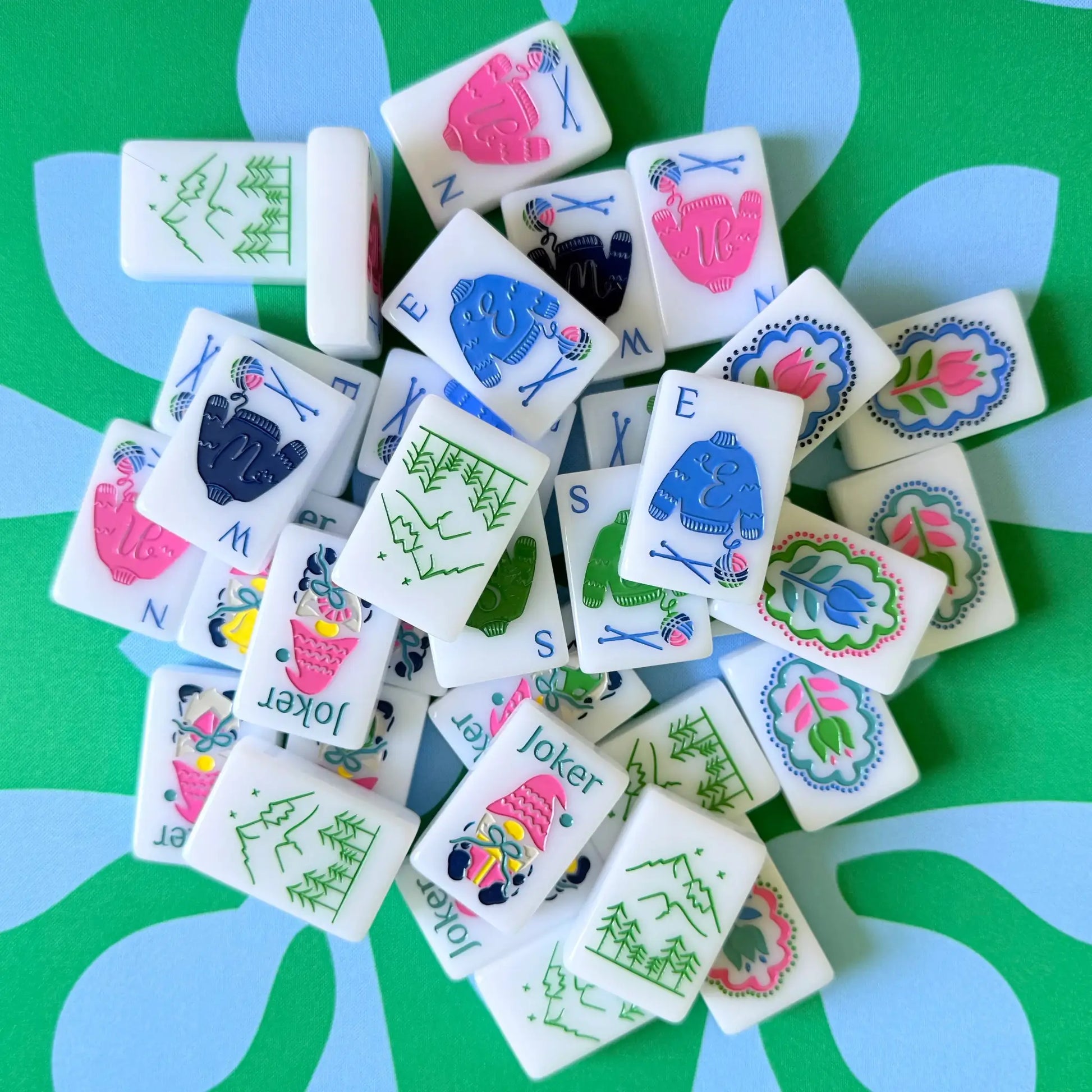 The Scandinavian Christmas Mahjong Collection's winds and jokers displayed on the Emerald Mist Mahjong Mat.