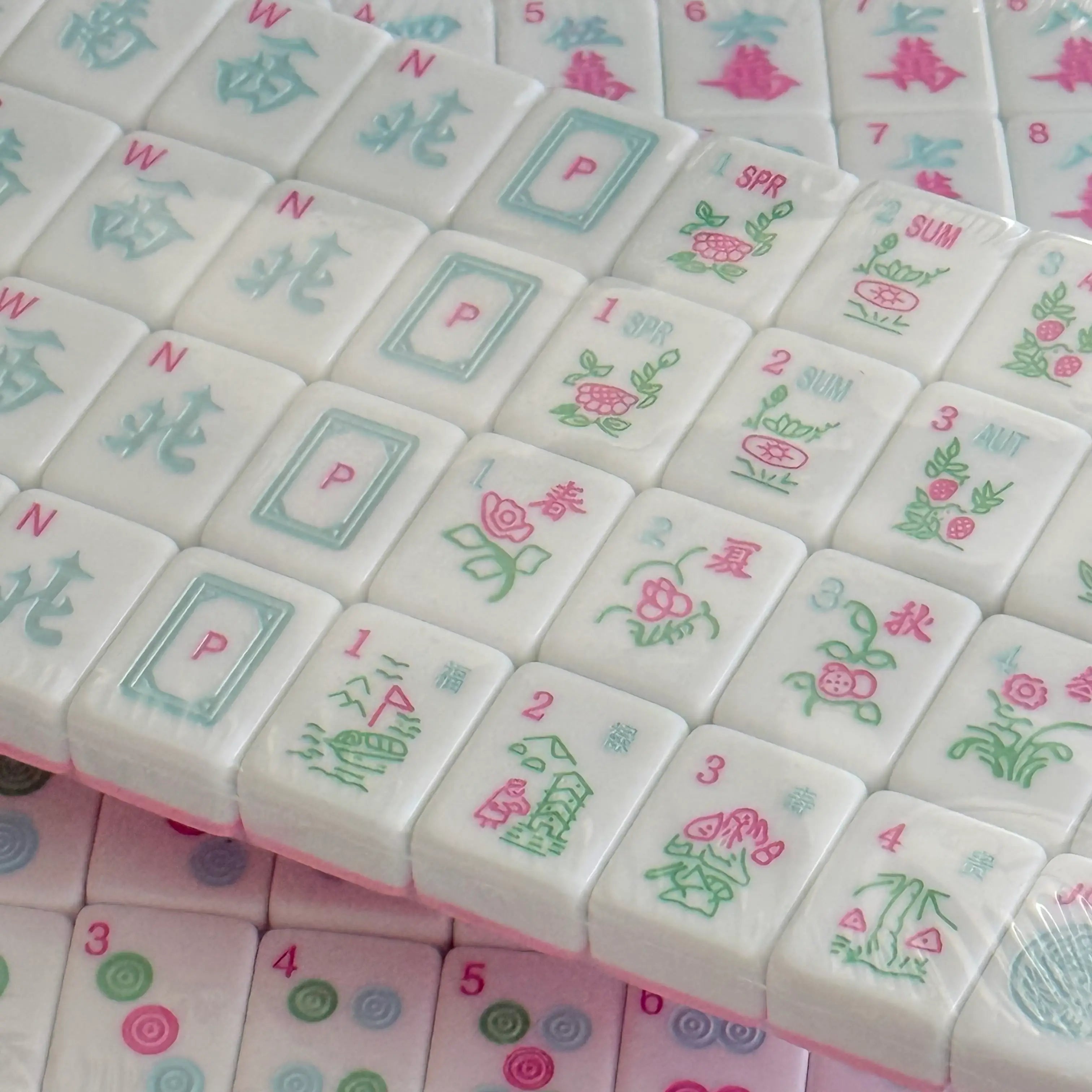 Close-up of Cabana Pink Mahjong tiles from Southern Springs in a soft pastel palette, shown as a detailed product image for the homepage.