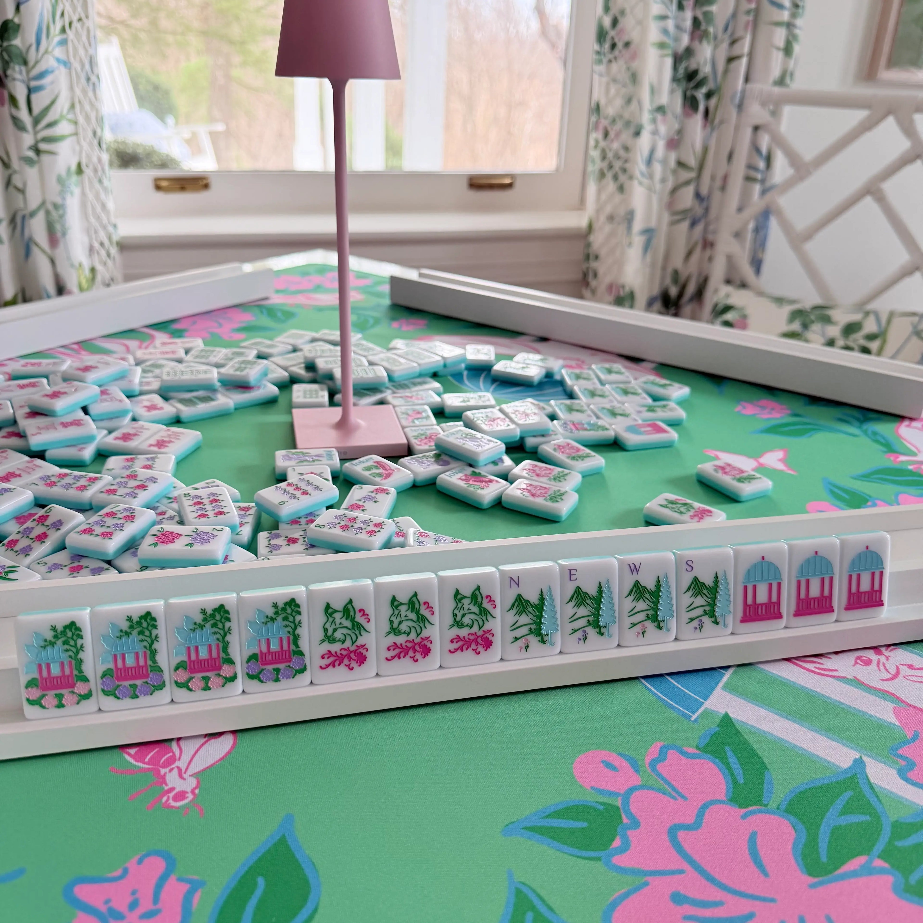 Southern Springs Mahjong homepage hero image featuring white tiles on a Southern Springs mat with a wooden rack.