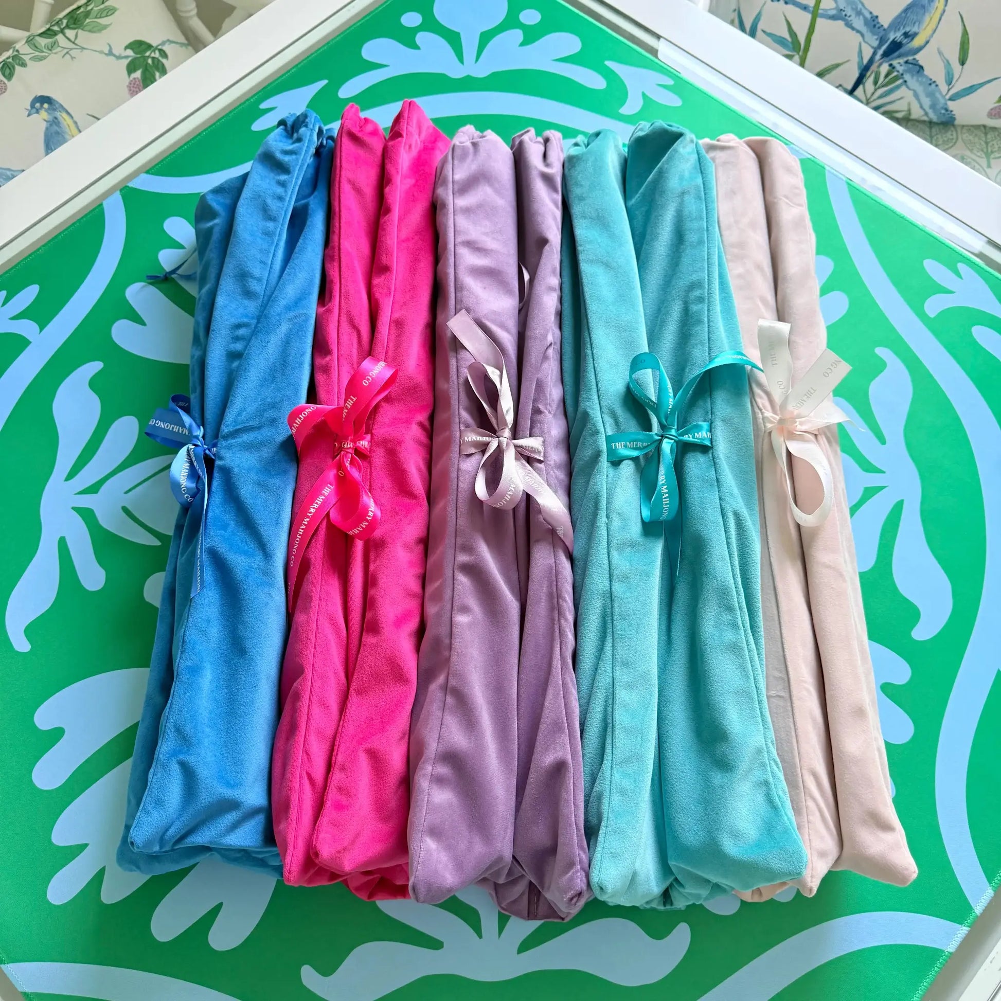 All of the velvet mahjong rack bag color options displayed together, including: blue, purple, hot pink, green and dusty light pink.