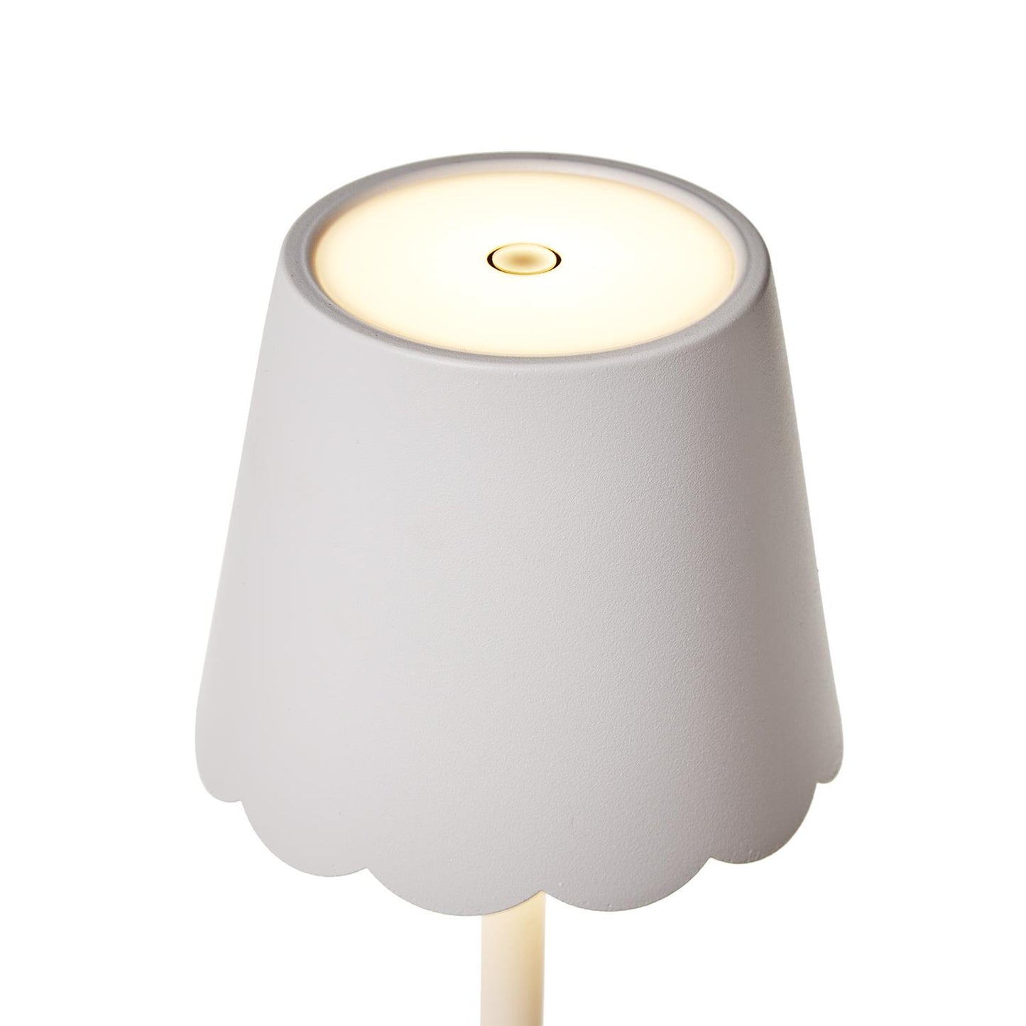 Close-up of scalloped shade on white LED table lamp
